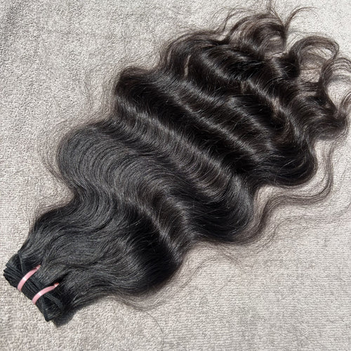 Black hair extensions on a textured surface