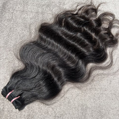 Black hair extensions on a textured surface