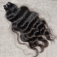 Curly hair bundle on a textured gray background