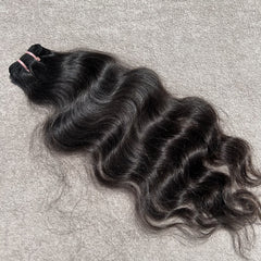 Curly hair bundle on a textured gray surface