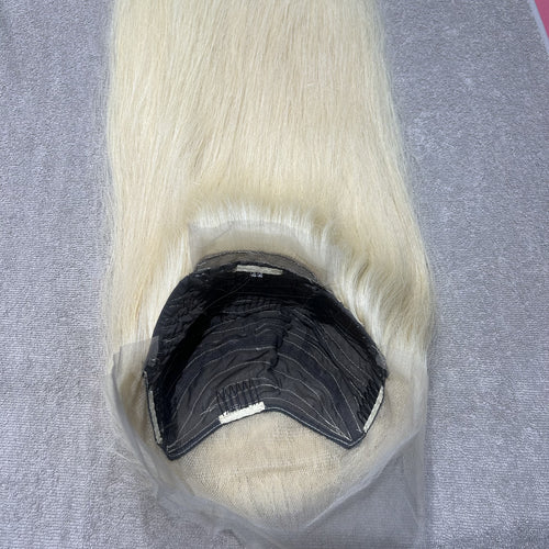 Blonde wig on a gray background