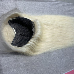 Blonde hair extensions on a gray surface