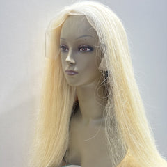 Mannequin head with long blonde wig on a plain background
