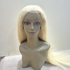 Blonde wig on a mannequin head against a white background